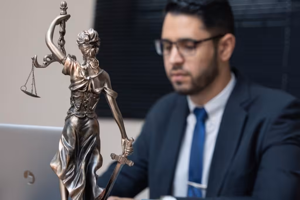 Estate planning attorney standing beside Lady Justice statue